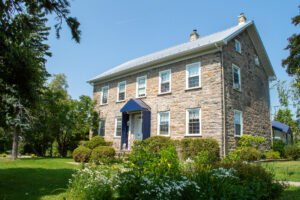 our intervention services rehab location in a farm house in rural quebec 2 stories with trees and lawn