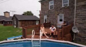 3 people sit by the pool at heritage discussing alcohol addiction